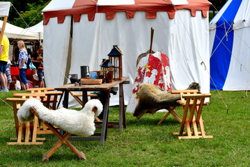 A close up on the display of various medieval items of eqipment, including tables, chairs, lamps,...