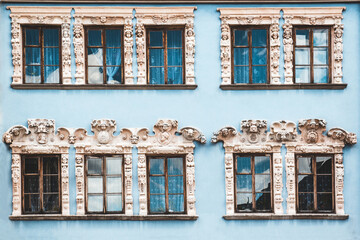 Ten windows on The blue facade of the old vintage houses
