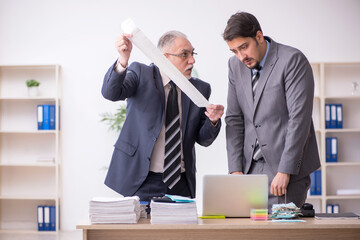Two male bookkeepers in budget planning concept in the office