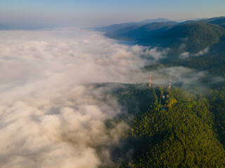 Aerial view over the Telecom tower on a mountain peak with sea of fog among the valley during the morning, Unseen travel in Mae Hong Son Northern Thailand