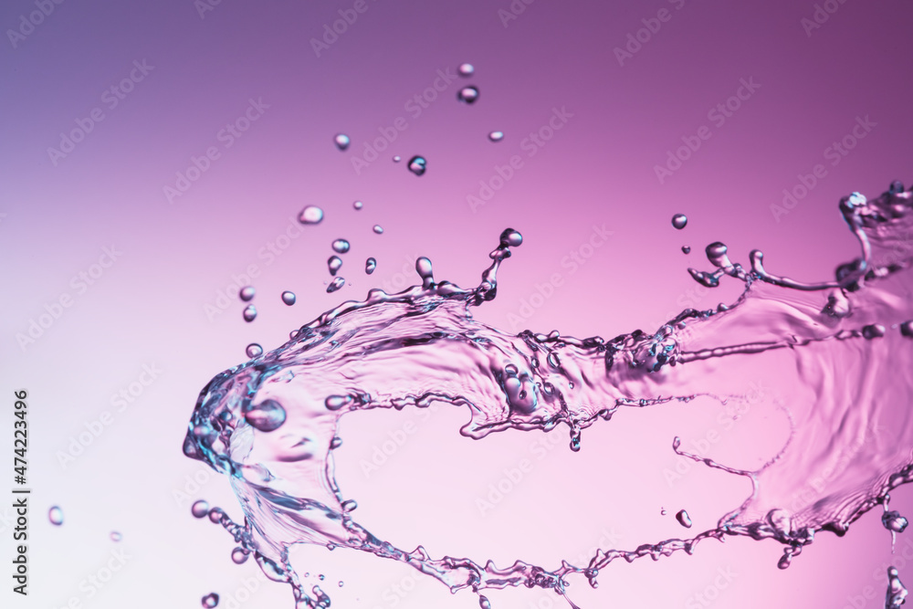 Wall mural Water splash on a purple color