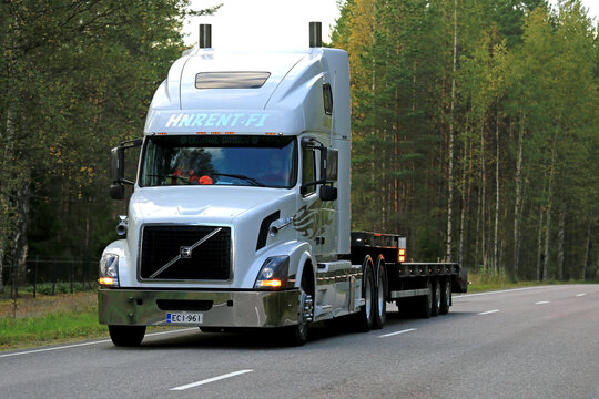 White Volvo VNL 64T Truck Semi Trailer on Highway