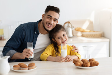 Cute Little Arab Girl Having Snacks With Daddy In Kitchen