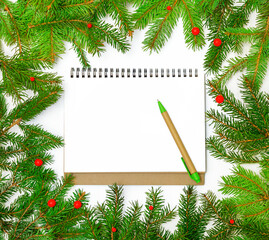 boknot and pen with green spruce branches