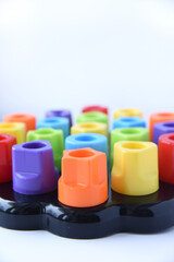 Children colorful sorter. Plastic kid chunky pegs toy on white background. Motor skills training figures
