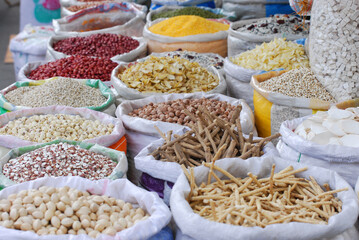 market with Asian seasoning stall and dried food