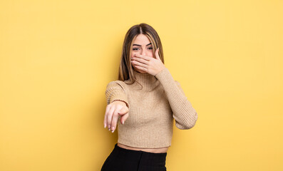 pretty caucasian woman laughing at you, pointing to camera and making fun of or mocking you