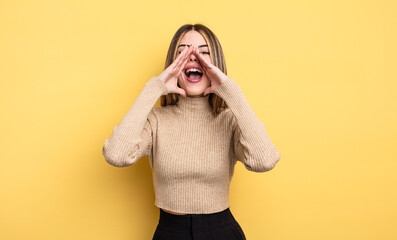 pretty caucasian woman feeling happy, excited and positive, giving a big shout out with hands next...