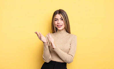 pretty caucasian woman feeling happy and successful, smiling and clapping hands, saying...