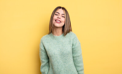 pretty caucasian woman with a big, friendly, carefree smile, looking positive, relaxed and happy,...