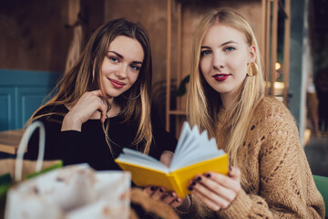 Young women reading notes in copybook