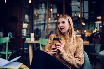 Young lady resting in modern cafe