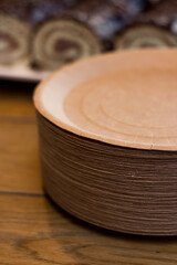 Paper plates with chocolate rolls. Disposable paper plates