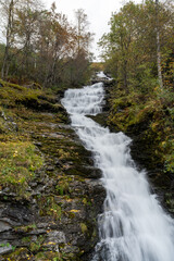 Fototapeta na wymiar Waterfall Hole in the village of Geiranger, Norway