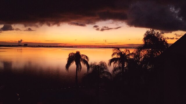 Sunset picture taken where it is stormy in one location, and sunny in the background. Taken from Tierra Verde, FL