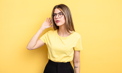 pretty caucasian woman looking serious and curious, listening, trying to hear a secret conversation...
