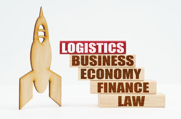 On the white surface there is a wooden rocket and planks, on the red plaque the inscription - LOGISTICS