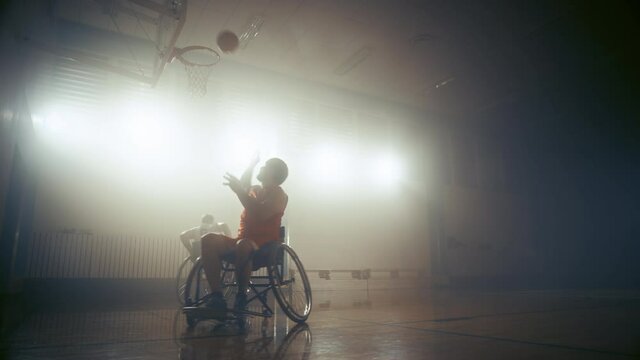 Wheelchair Basketball Game One on One: Professional Players Competing, Dribbling, Shooting it Successfully, Score a Perfect Goal. Determination, Skill of People with Disability. Slow Motion