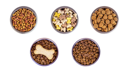 Top view of brown biscuit bones and crunchy organic kibble pieces for dog feed in a metal bowl set isolated on white background. Healthy dry pet food concept. - 474238475
