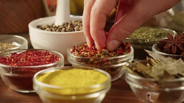 Colourful spices in glass bowls close-up. Middle eastern and arabian culture. Seasoning and flavors. Pepper, coriander, cinnamon, turmeric, paprika, cumin. Different kinds of dry herbs for cooking. 