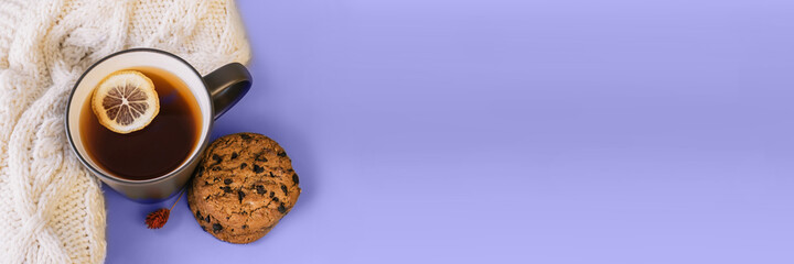 Very Peri. Color of the year 2022. Violet, purple colors. Autumn tea. Sweater, maple leaves, cookies and cup of tea with lemon. Cozy fall season