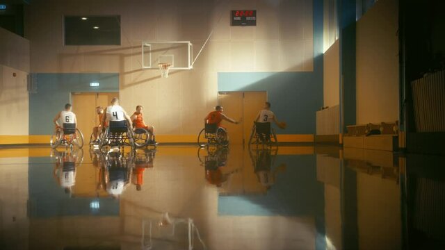 Wheelchair Basketball Game Court: Players Competing, Dribbling, Shooting it Successfully, Score Goal Points. Determination, Skill of People with Disability. Energetic Fast Paced Wide Shot