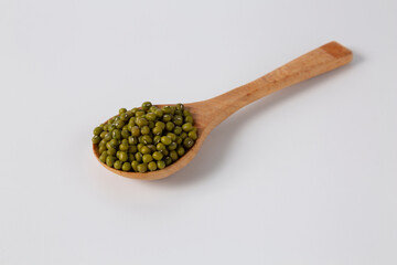 mung bean in wood spoon on white background studio shot