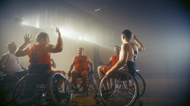 Wheelchair Basketball Game Court Winning Team Celebrate Victory, Cheer and High Five. Players Compete, Shoot, Score Goal Points. Determination, Skill of People with Disability. Handheld Dolly Shot