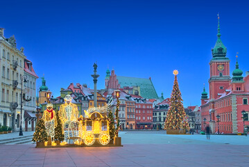Christmas decorations and Royal Castle at daybreak in the Warsaw Old Town. Poland
