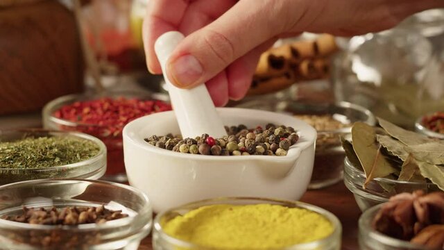 Colourful spices in glass bowls close-up. Middle eastern and arabian culture. Seasoning and flavors. Pepper, coriander, cinnamon, turmeric, paprika, cumin. Different kinds of dry herbs for cooking. 