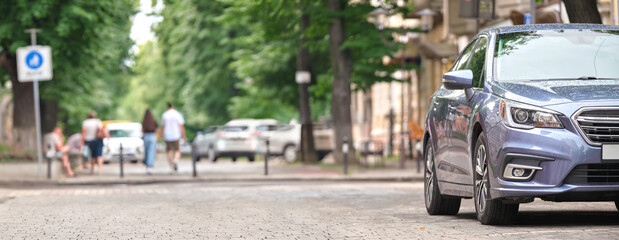 Close up of a car parked illegally against traffic rules on pedestrian city street side