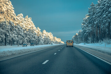 Winter asphalt road.  Winter road and trees with snow and Latvian landscape. Soft focus on photos.