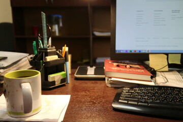 mug, lamp, pens on the office table