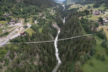 suspension bridge over forest from aerial view