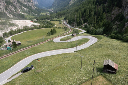 road and curves over valley from aerial view