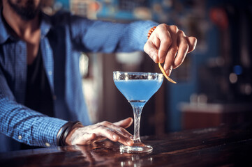 Bartender makes a cocktail on the saloon