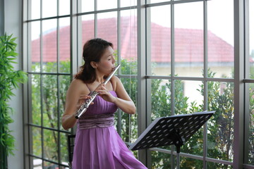woman musician playing classical flute music instrument, workshop for performance concert