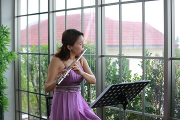 woman musician playing classical flute music instrument, workshop for performance concert © chokniti