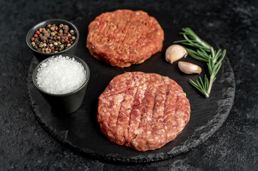 raw cutlets for making burger on stone background