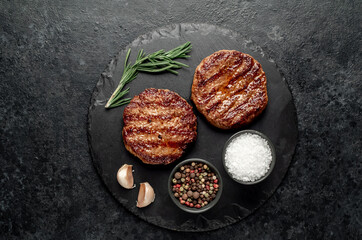 grilled cutlets for making burger on stone background