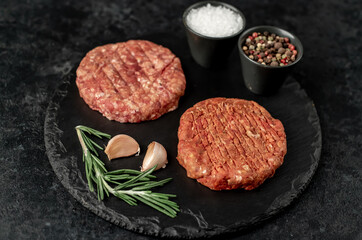 raw cutlets for making burger on stone background
