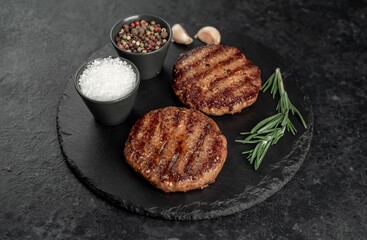 grilled cutlets for making burger on stone background