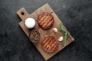 grilled cutlets for making burger on stone background