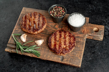 grilled cutlets for making burger on stone background