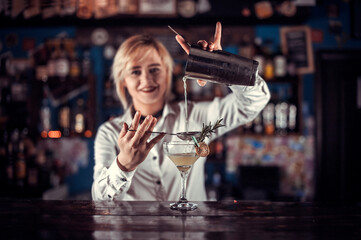 Girl barman concocts a cocktail on the porterhouse