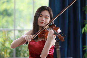 young woman violinist musician playing workshop classical violin music at home studio