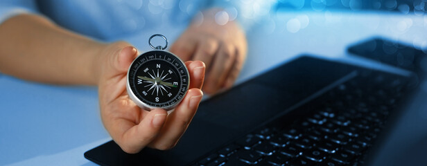 Business person who uses a navigation compass to resume business development in the economic...