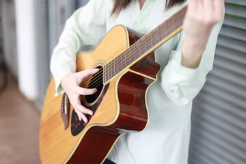 Young Asian woman musician person playing guitar music instrument with happy lifestyle