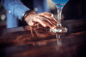 Bartender creates a cocktail on the saloon