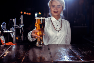 Girl bartender mixes a cocktail in the saloon